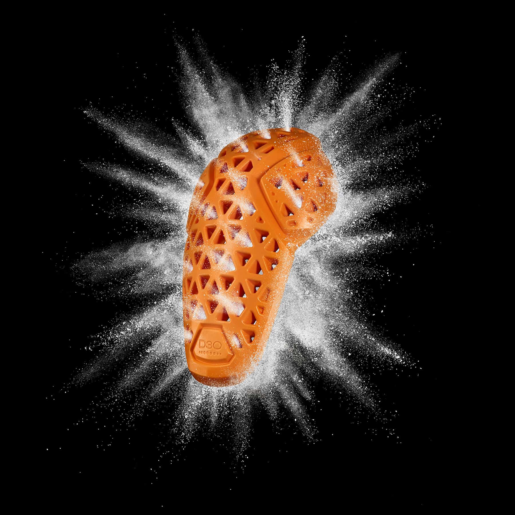 Black background image showing orange D3O elbow armour and breathability